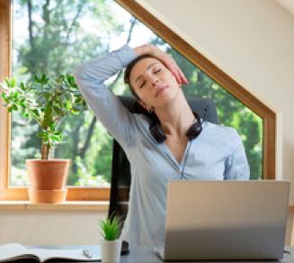 jeune femme qui fait de l’exercice et s’étire devant son ordinateur portable à la maison, en tété travail, pour préserver son capital santé.