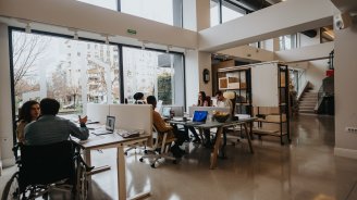 Équipe de salariés dans des bureaux d'entreprise, illustrant la valeur d'un contrat collectif santé et prévoyance pour les TPE et PME.